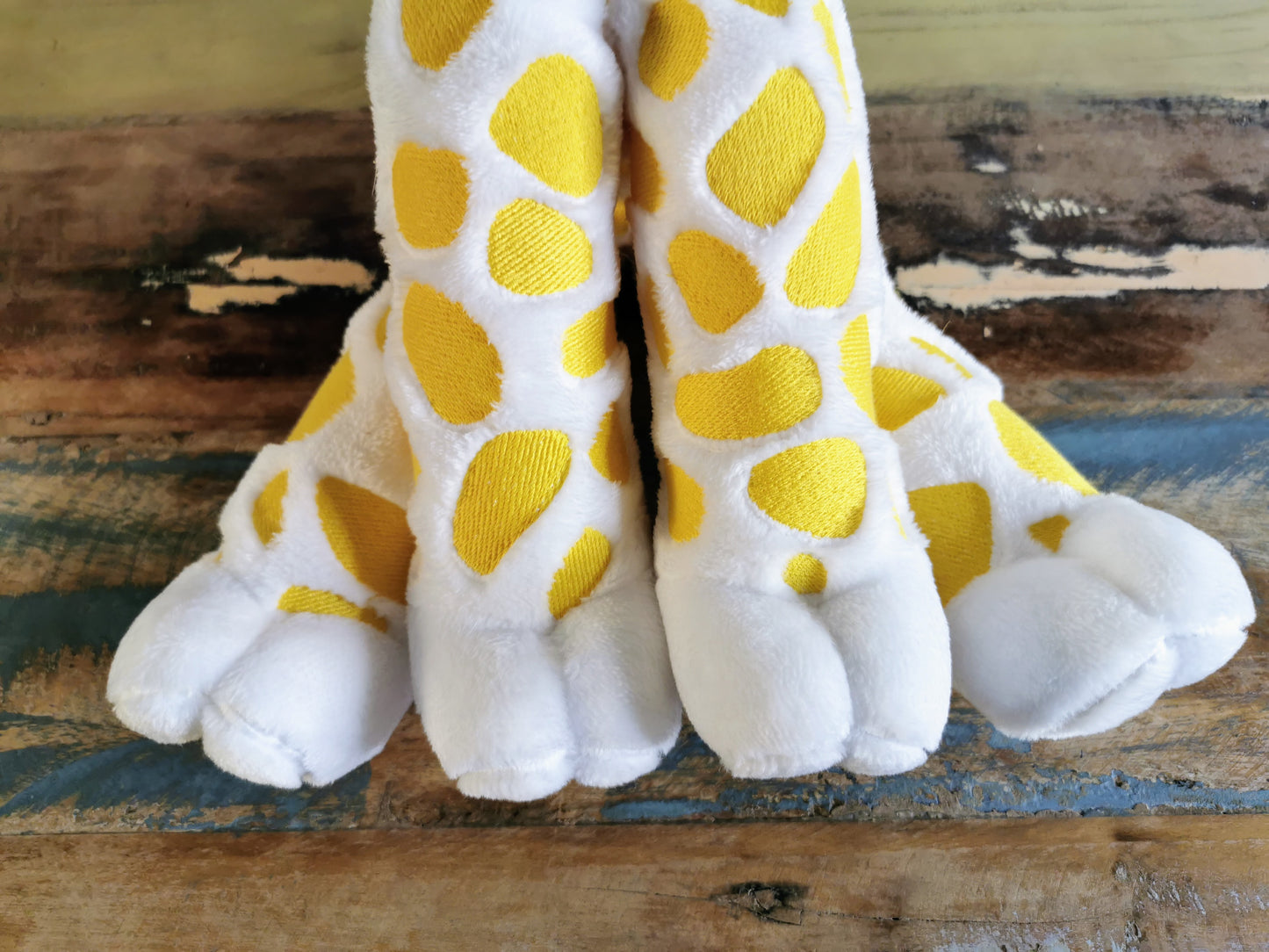 Seated Baby Giraffe plush, embroidered cuddling giraffe toy in white plush with bright yellow embroidery, pink stripe bow